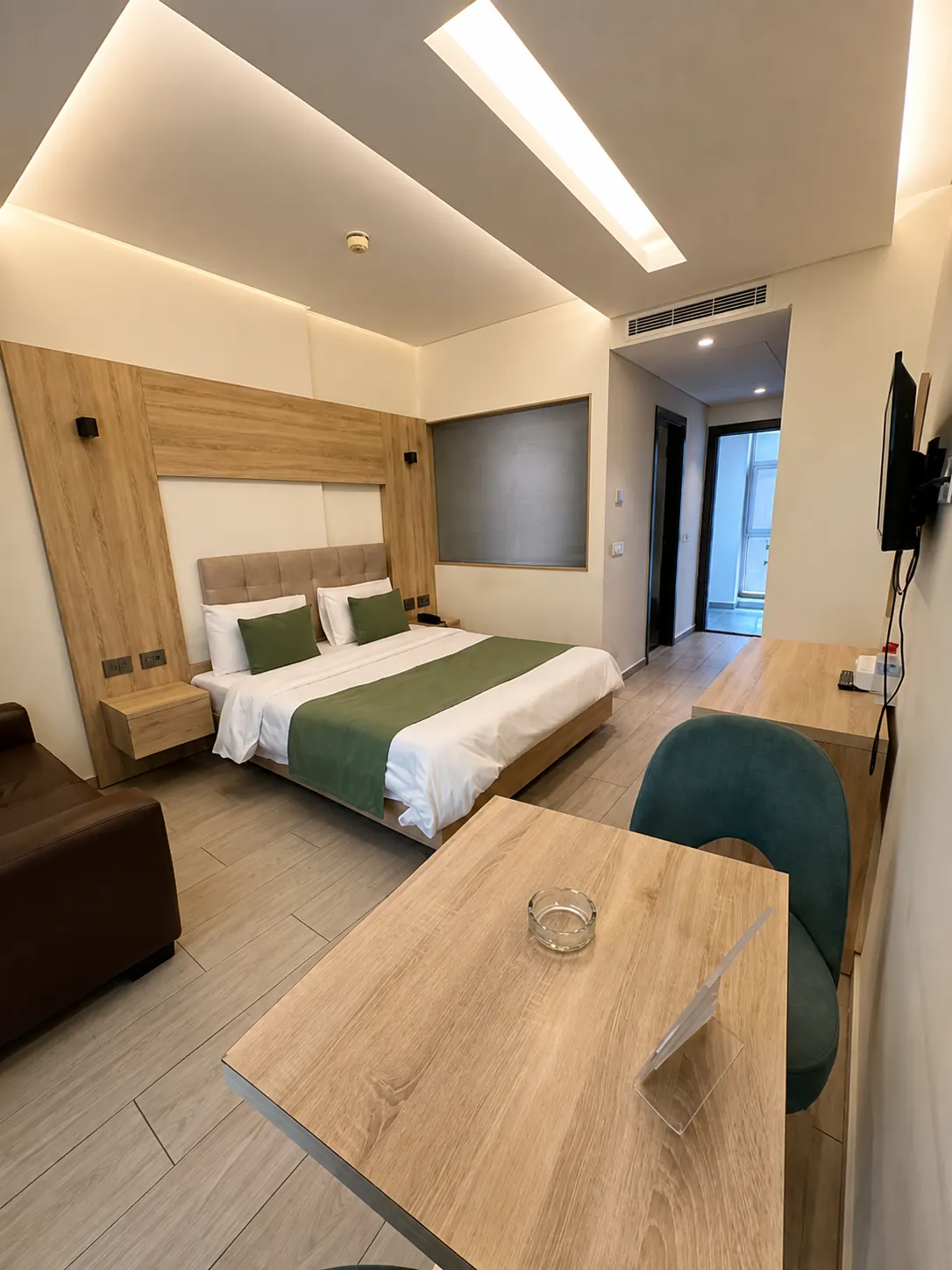 Modern hotel room with double bed and work desk